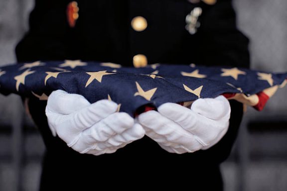 Marine with Folded Memorial Flag