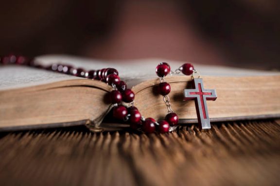 Bible with Rosary Beads and Cross